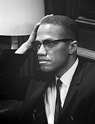 Malcolm X waiting for a press conference to begin on March 26, 1964