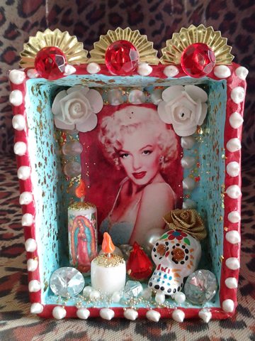 Marilyn roams the netherworld snacking on paste diamonds, flameless candles, plastic flowers, and bedazzled skulls.