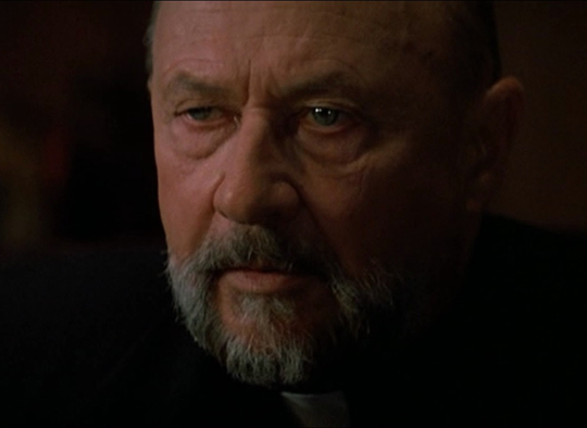 Donald Pleasance is worried as "Priest" in PRINCE OF DARKNESS.