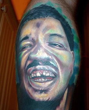 The only thing more hip and daring than pretending to like the music of Wesley Willis is getting a huge tattoo of his face on your calves.