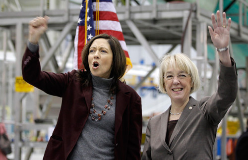 WA senators Cantwell (left) and Murray (right) enjoined in corporate cheer at a rally at Boeing in Seattle